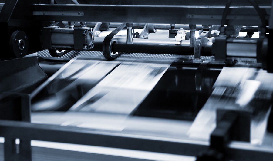 A commercial printer producing bulk prints, highlighting cost-effective printing solutions.